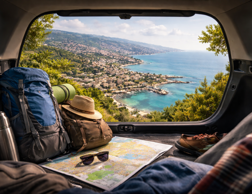 Weekend road trip from Beirut showing a coastal Lebanese town viewed from a car trunk with travel gear and backpacks